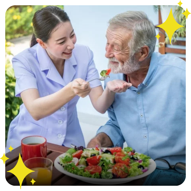 a nurse feeding an elderly man
